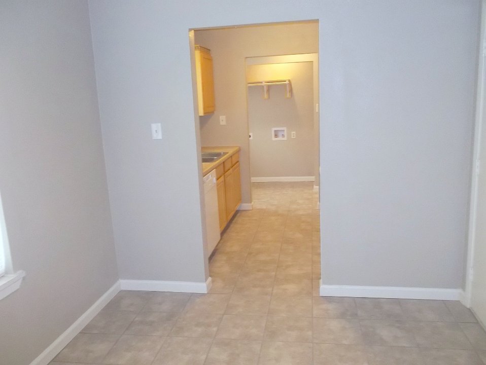 Looking from the dining room through the kitchen into the laundry area.